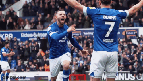 A Soccer Player Wearing A Number 7 Jersey Celebrates With His Teammate GIF