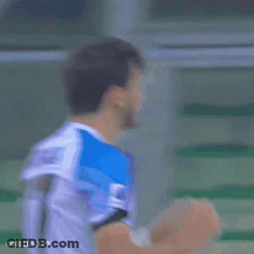 A Soccer Player Wearing A Number 77 Jersey Covers His Face With His Hands GIF