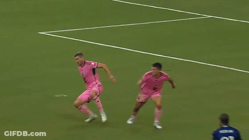 A Soccer Player Wearing A Number 77 Jersey Stands In Front Of A Net GIF