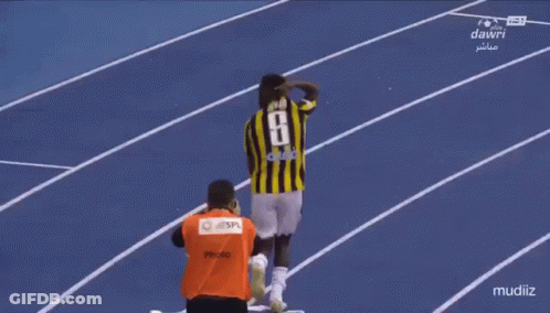 A Soccer Player Wearing A Number 8 Jersey Stands On A Track GIF