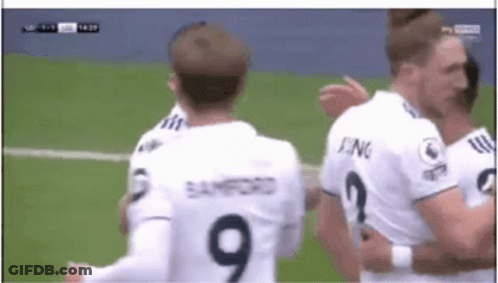 A Soccer Player Wearing A Number 9 Jersey Is Hugging Another Player GIF