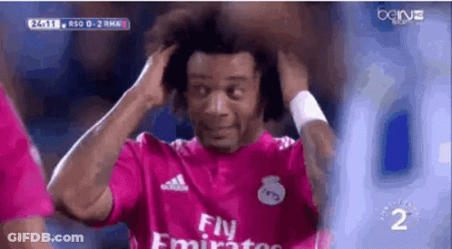 A Soccer Player Wearing A Pink Fly Emirates Jersey Is Holding His Hair . GIF
