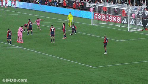 A Soccer Player Wearing A Pink Jersey With Suarez On The Back Is Hugging Another Player GIF