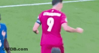 A Soccer Player Wearing A Pink Jersey With The Number 9 On It Is Kicking A Ball . GIF