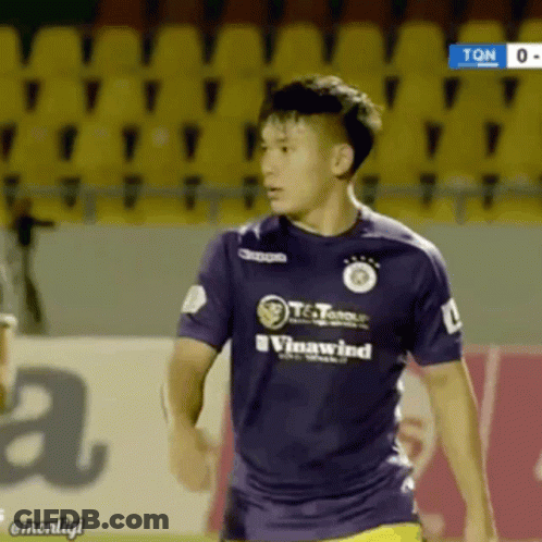 A Soccer Player Wearing A Purple Shirt That Says Vinawind On It GIF