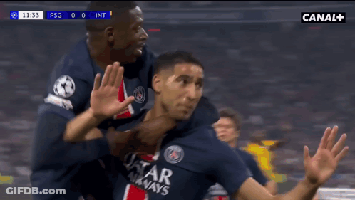 A Soccer Player Wearing A Qatar Airways Jersey Is Being Hugged By Another Player GIF