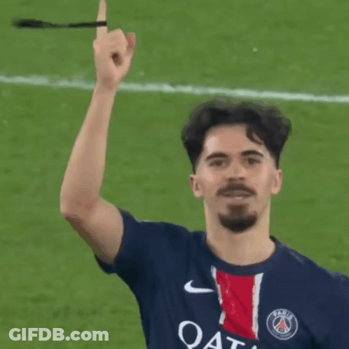 A Soccer Player Wearing A Qatar Shirt Holds Up His Finger GIF