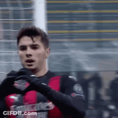 A Soccer Player Wearing A Red And Black Jersey That Says Emirates GIF