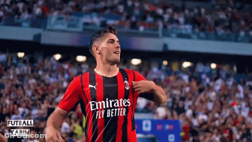 A Soccer Player Wearing A Red And Black Jersey With Emirates Fly Better On It GIF