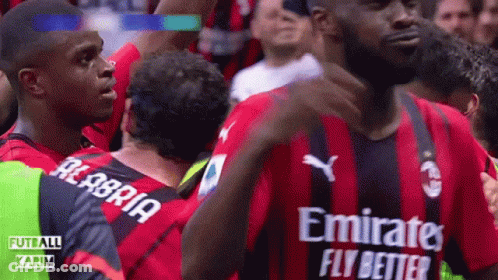 A Soccer Player Wearing A Red And Black Jersey With Emirates Fly Better Written On It GIF