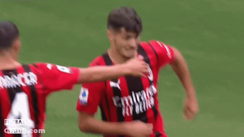 A Soccer Player Wearing A Red And Black Jersey With Emirates Fly Better Written On It GIF