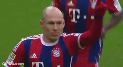 A Soccer Player Wearing A Red And Blue Adidas Jersey Is Giving A High Five . GIF