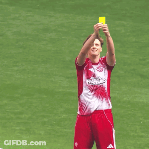 A Soccer Player Wearing A Red And White Jersey That Says Fastble Holds Up A Yellow Card GIF