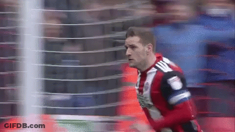 A Soccer Player Wearing A Red And White Jersey With Adidas On The Back GIF