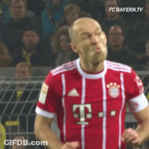 A Soccer Player Wearing A Red And White Jersey With The Letter T On It Is Making A Funny Face . GIF