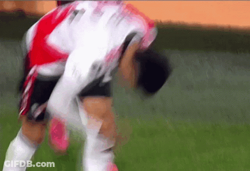 A Soccer Player Wearing A Red And White Jersey With The Number 11 On It GIF