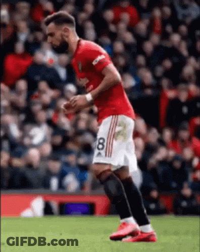 A Soccer Player Wearing A Red And White Jersey With The Number 8 On It Is Running On The Field . GIF