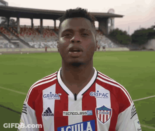 A Soccer Player Wearing A Red And White Jersey With The Word Aguila On The Front GIF