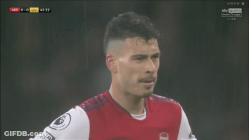A Soccer Player Wearing A Red And White Jersey With The Word Arsenal On The Front GIF