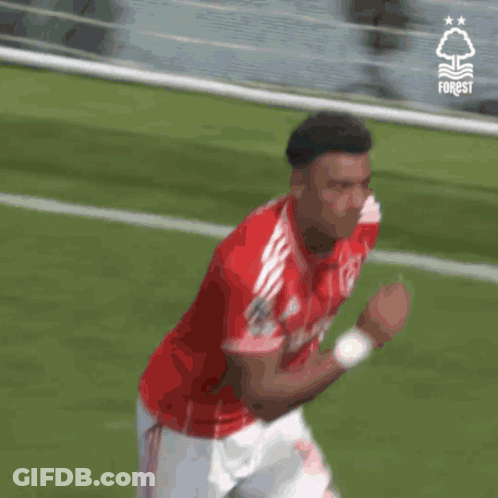 A Soccer Player Wearing A Red And White Jersey With The Word Forest On It GIF