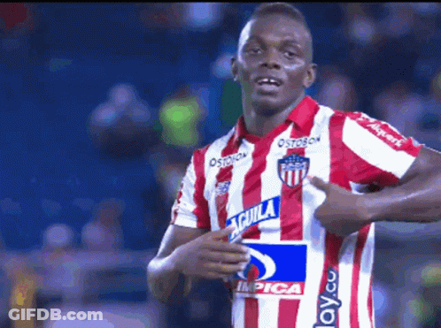 A Soccer Player Wearing A Red And White Striped Jersey With Aguila On It GIF