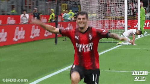 A Soccer Player Wearing A Red Emirates Jersey Celebrates GIF
