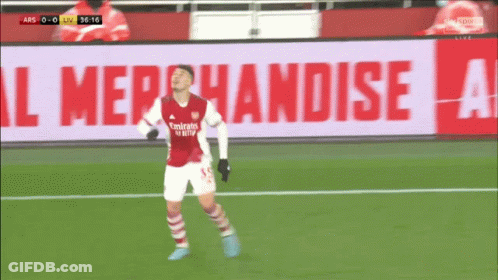 A Soccer Player Wearing A Red Emirates Jersey Celebrates A Goal GIF