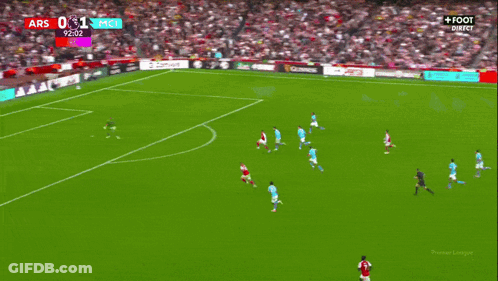 A Soccer Player Wearing A Red Emirates Jersey Is Being Helped By Another Player GIF