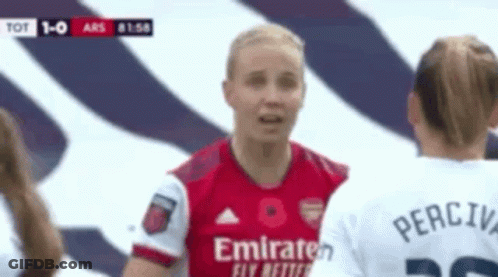 A Soccer Player Wearing A Red Emirates Jersey Is Talking To Another Soccer Player . GIF