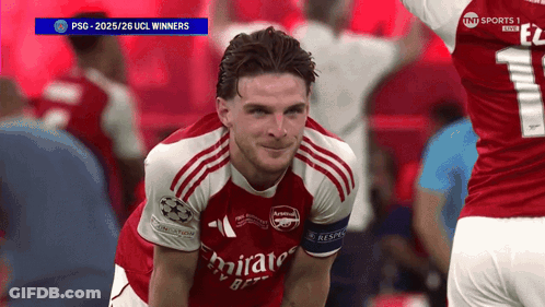A Soccer Player Wearing A Red Emirates Jersey Smiles GIF