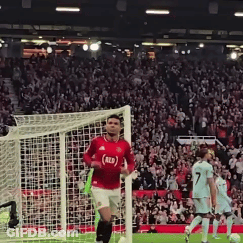 A Soccer Player Wearing A Red Jersey Is Running Towards A Goal GIF