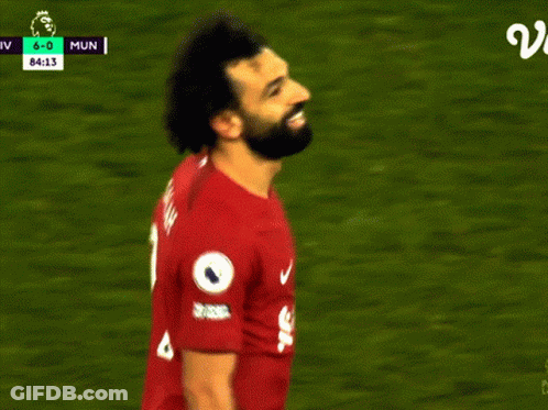 A Soccer Player Wearing A Red Jersey With Salah On It GIF