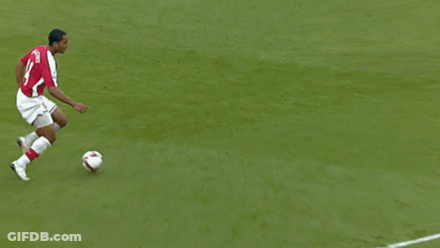 A Soccer Player Wearing A Red Jersey With The Name Alvarez On The Back Is Kicking The Ball GIF