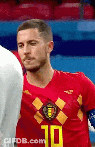 A Soccer Player Wearing A Red Jersey With The Number 10 On It Is Standing Next To Another Player On The Field . GIF