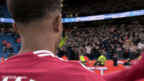 A Soccer Player Wearing A Red Jersey With The Number 44 On It GIF
