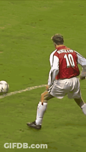 A Soccer Player Wearing A Red Shirt That Says ' Dri ' On It Is Being Tackled By Another Player GIF