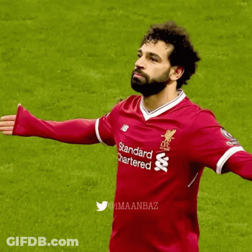 A Soccer Player Wearing A Red Shirt That Says Standard Chartered On It GIF