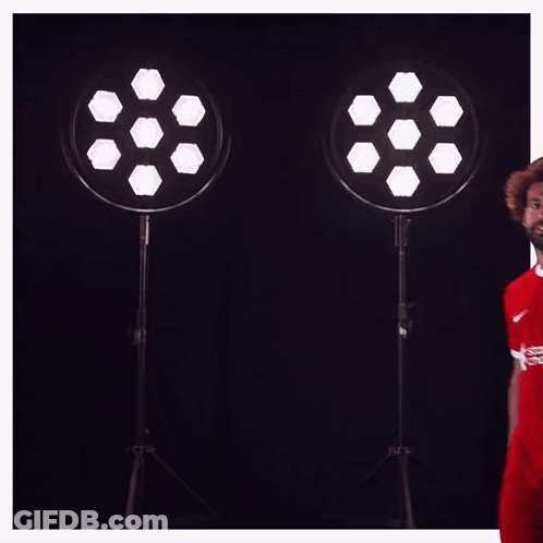 A Soccer Player Wearing A Red Shirt That Says Standard Chartered On It GIF