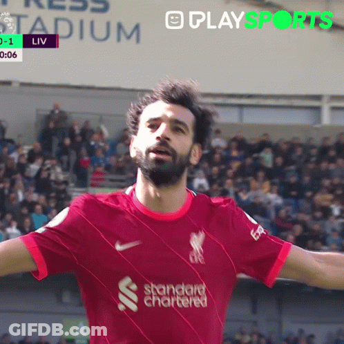 A Soccer Player Wearing A Red Shirt That Says Standard Chartered On It GIF