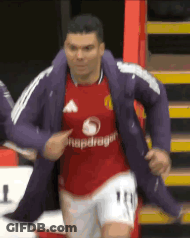 A Soccer Player Wearing A Red Snapdragon Jersey Is Being Helped By Another Player GIF