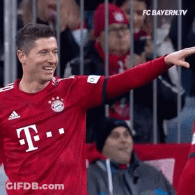 A Soccer Player Wearing A Red T-Mobile Jersey Is Pointing GIF