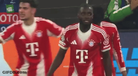 A Soccer Player Wearing A Red T-Mobile Jersey Stands With His Teammates GIF