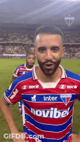 A Soccer Player Wearing A Red , White And Blue Jersey With The Word Novibet On It . GIF