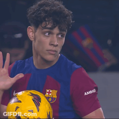 A Soccer Player Wearing A Shirt That Says Ambils Holds A Yellow Ball GIF