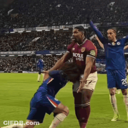 A Soccer Player Wearing A Shirt That Says Boole Sports Is Being Tackled By Another Player GIF