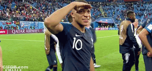 A Soccer Player Wearing A Shirt With The Number 10 On It Salutes The Crowd . GIF