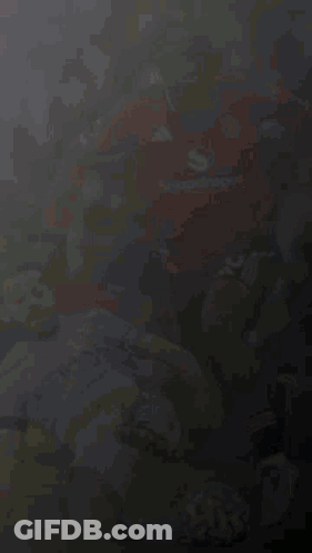 A Soccer Player Wearing A Snapdragon Jersey Is Playing Soccer With Another Player GIF