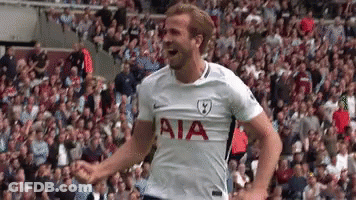 A Soccer Player Wearing A White Aia Jersey Is Standing In Front Of A Crowd . GIF