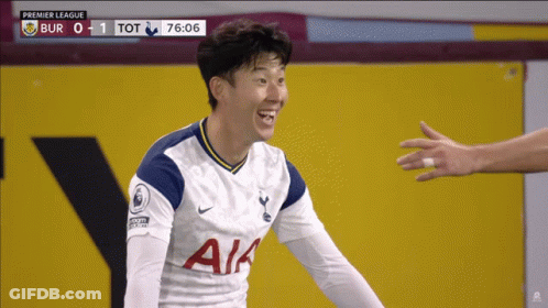 A Soccer Player Wearing A White Aia Jersey Smiles At Someone GIF