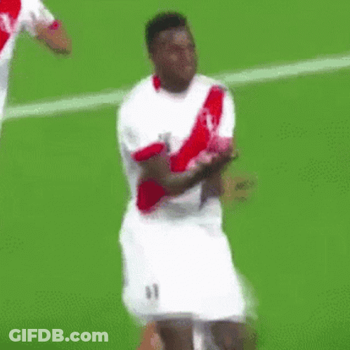 A Soccer Player Wearing A White And Red Jersey Is Dancing On The Field . GIF